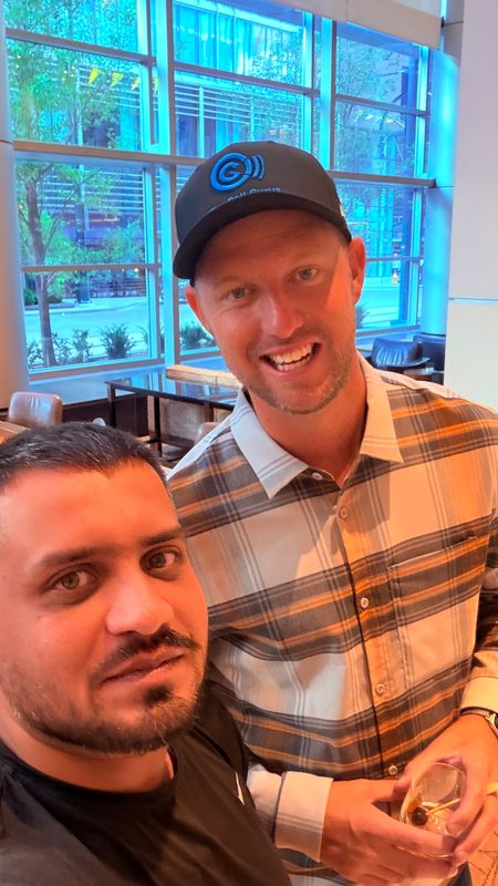 Selfie of Wali Zuberi with a fellow attendee in a Contact.io 2026 lounge area