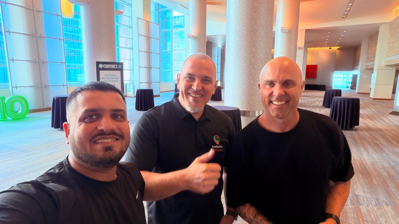 Wali Zuberi taking a group selfie with two fellow attendees at the Contact.io 2026 opening networking reception in Denver