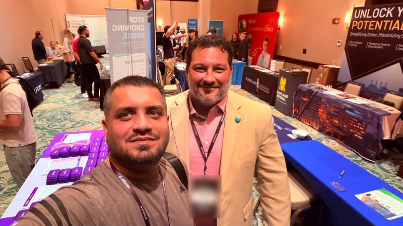 Selfie of Wali Zuberi with a fellow attendee on the MedicareCon 2026 expo floor